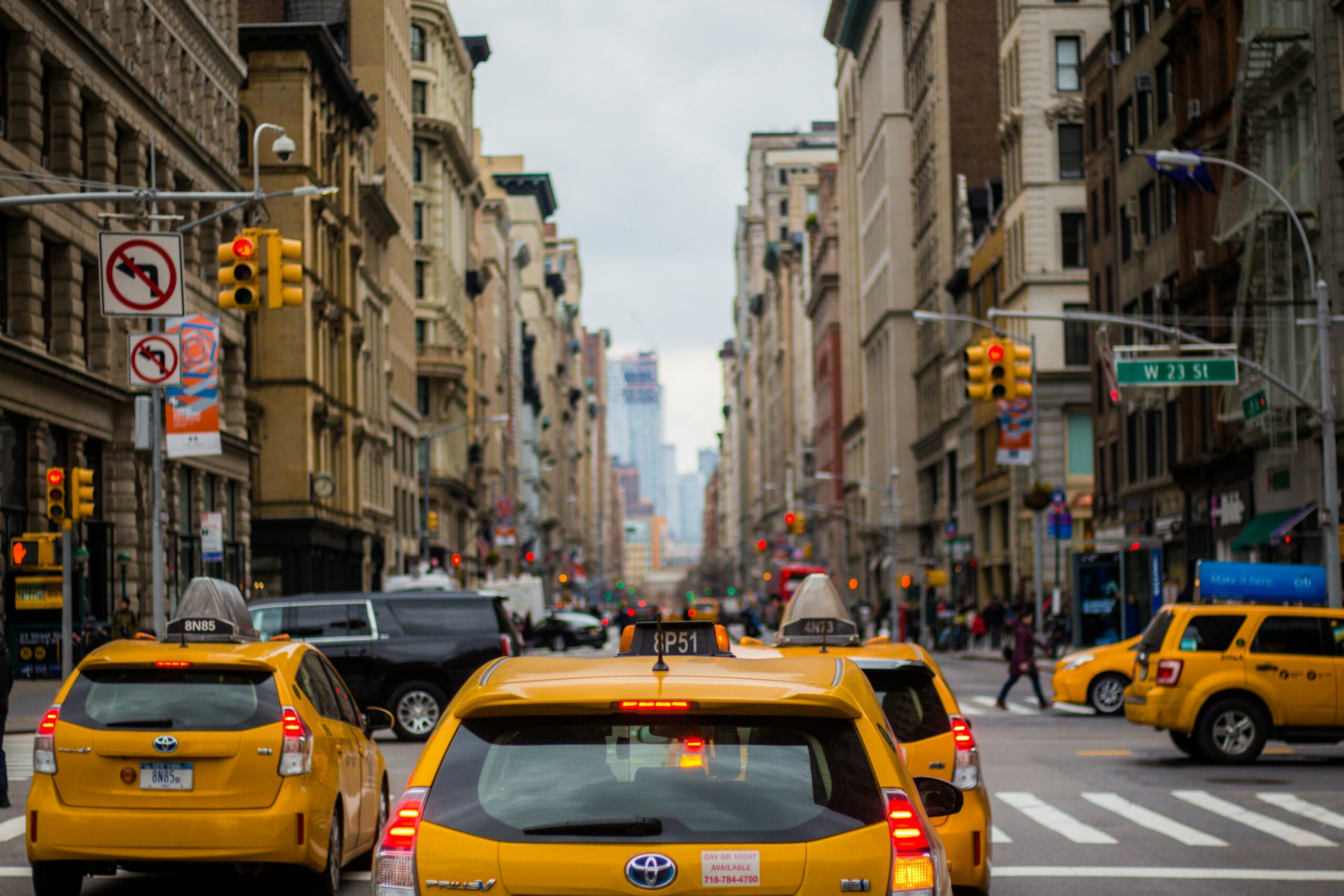 Three yellow taxis on the street in New York