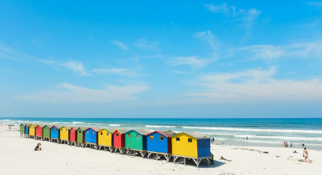 A row of colorful wooden houses along the beach