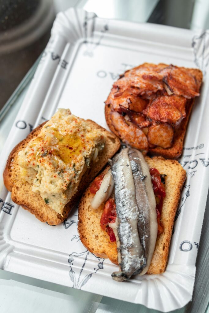 Plastic plate with three sandwiches ala tapas