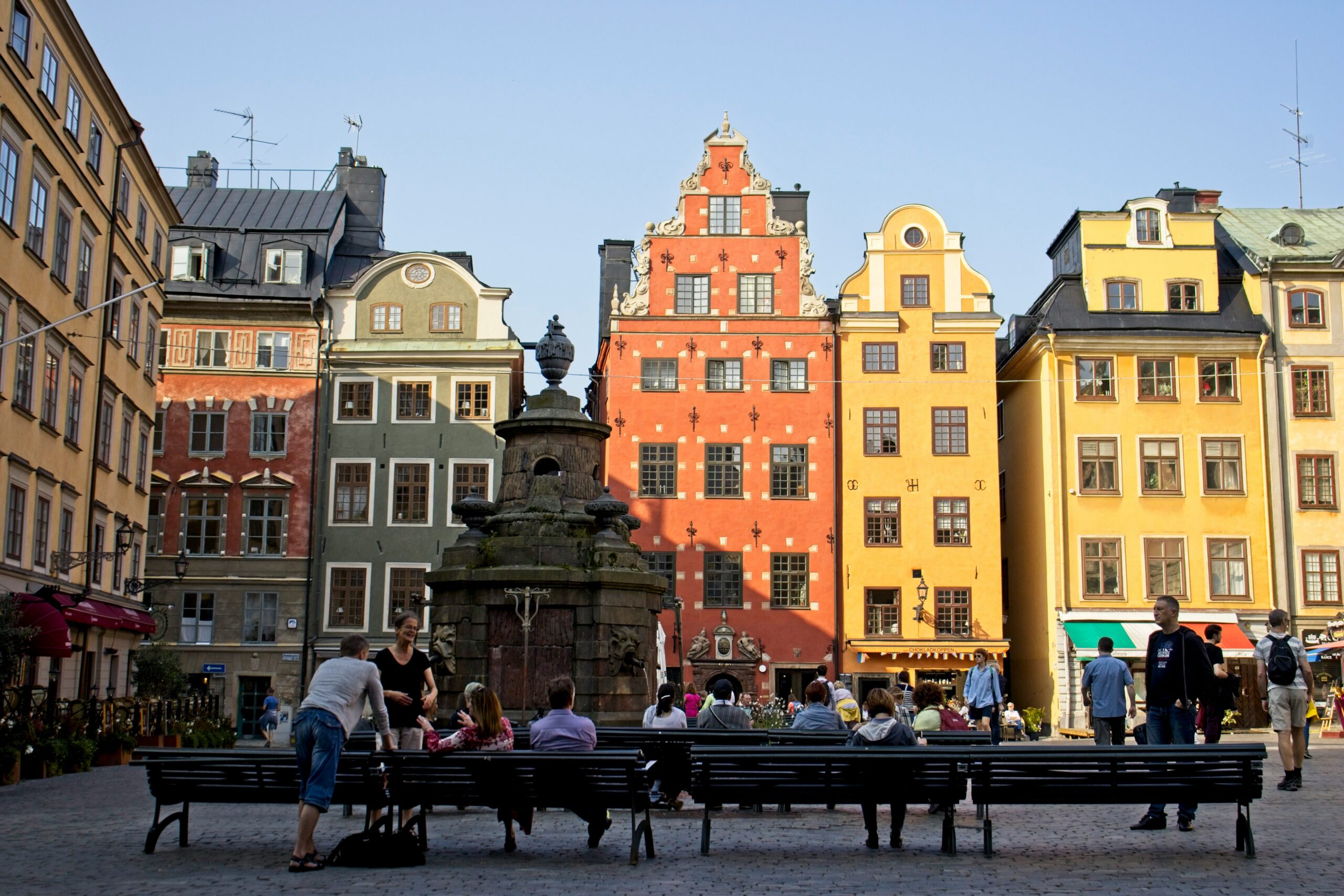 Some people sit on benches in Stockholm's Old Town