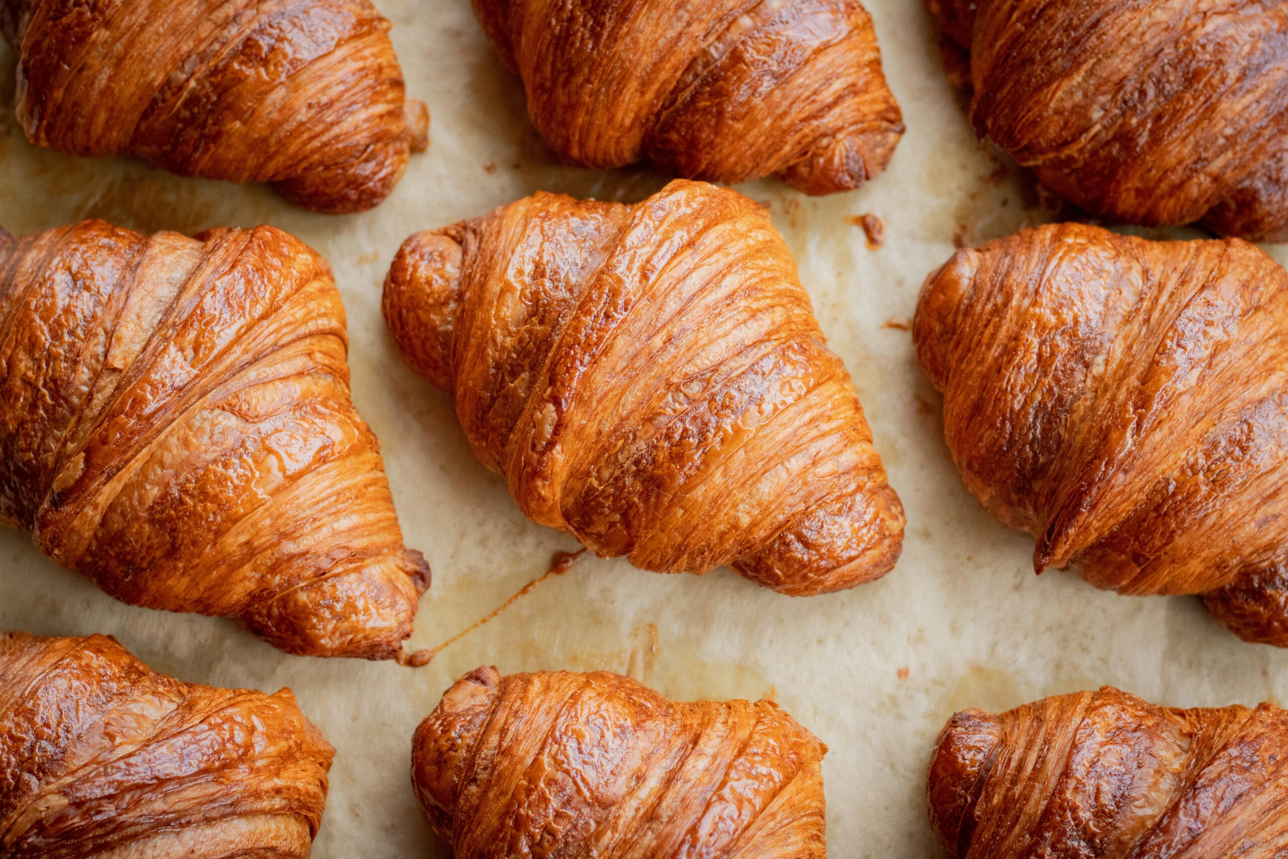 Several croissants on a baking tray