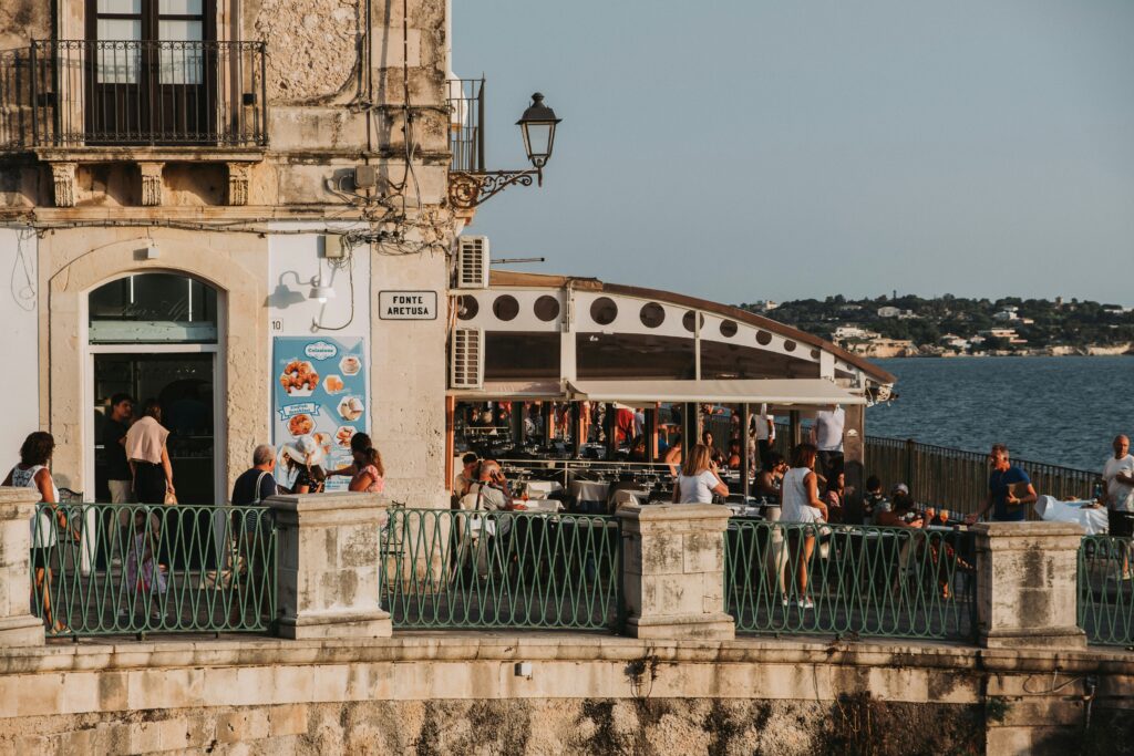 Several people stroll along the promenade on a sunny day