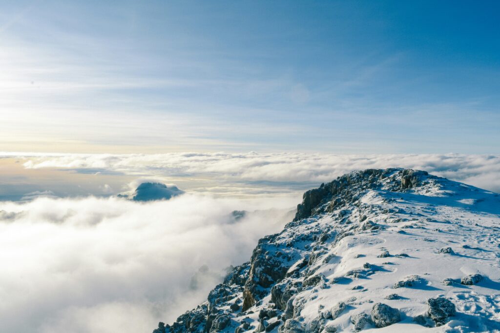 Kilimanjaro's snow-covered peaks with floating clouds around them