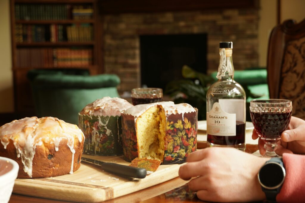 Two hands on a table, where Panettone is standing