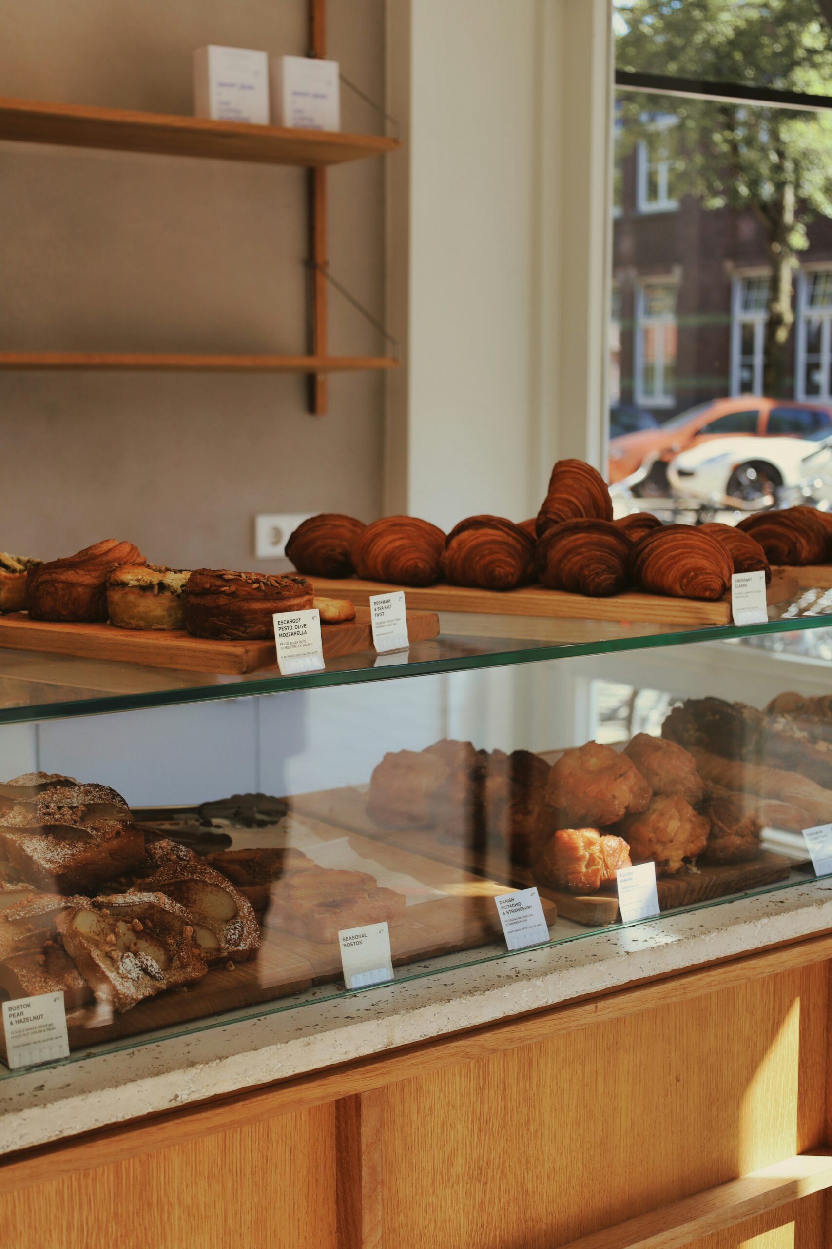 A display case in a minimalist shop with many croissants