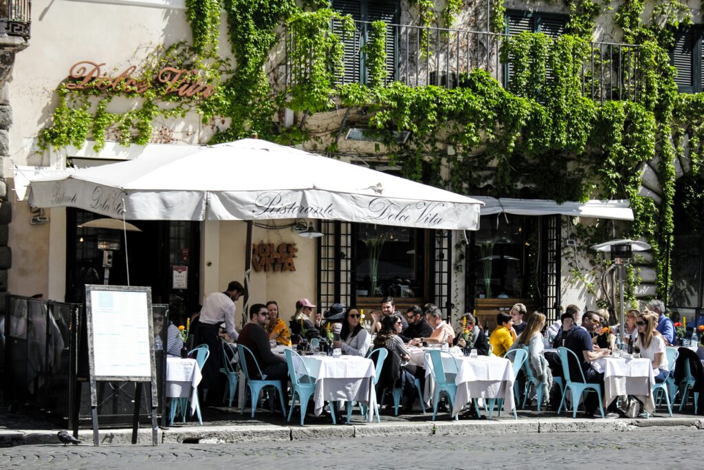 People sitting on terrace in cafe on a sunny day